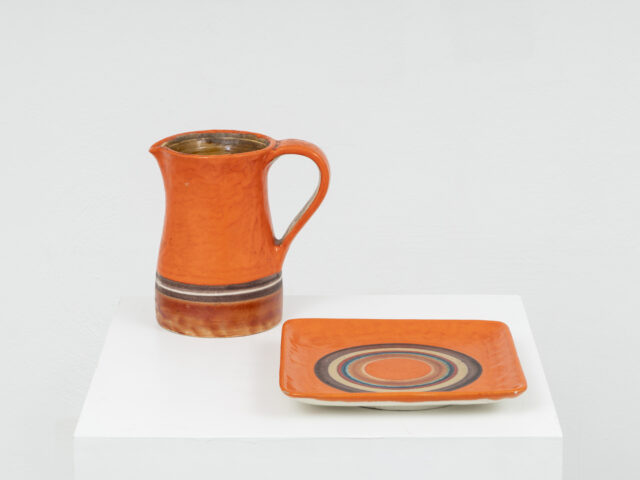 Orange ceramic pitcher and plate