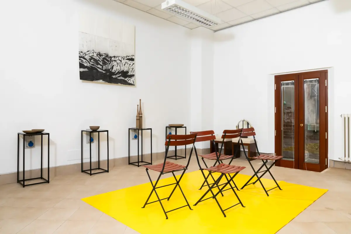 room view in 1+1 showroom for biennale arte 2026, venezia, zanotta chairs, gambone ceramics and a drawing by fabio sonego